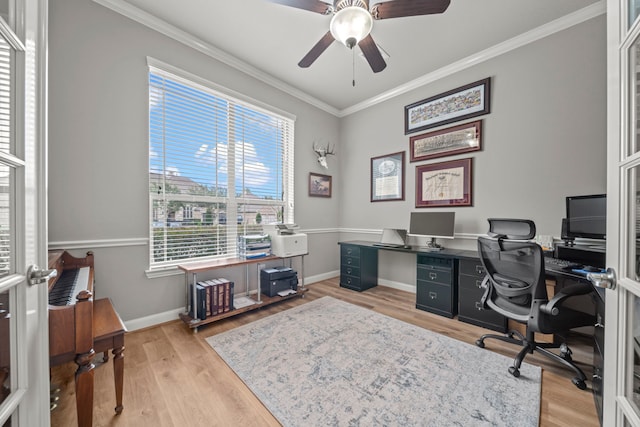 office featuring light wood-type flooring, a wealth of natural light, ornamental molding, and ceiling fan