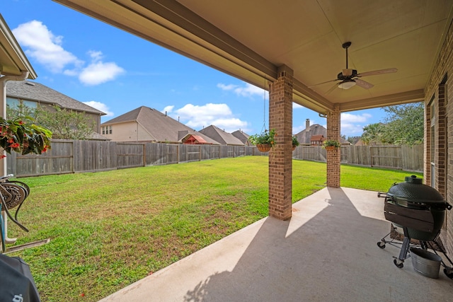 view of yard featuring ceiling fan and a patio area