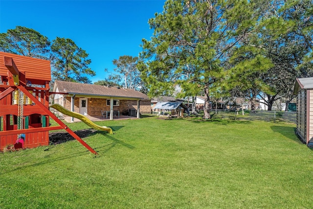 view of yard with a playground and a patio