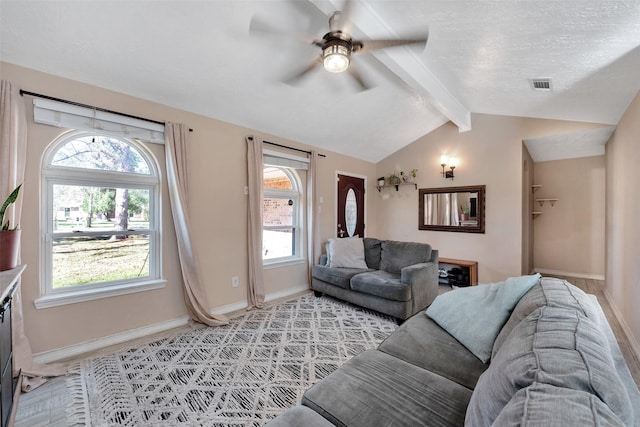 living room featuring a textured ceiling, lofted ceiling with beams, and ceiling fan