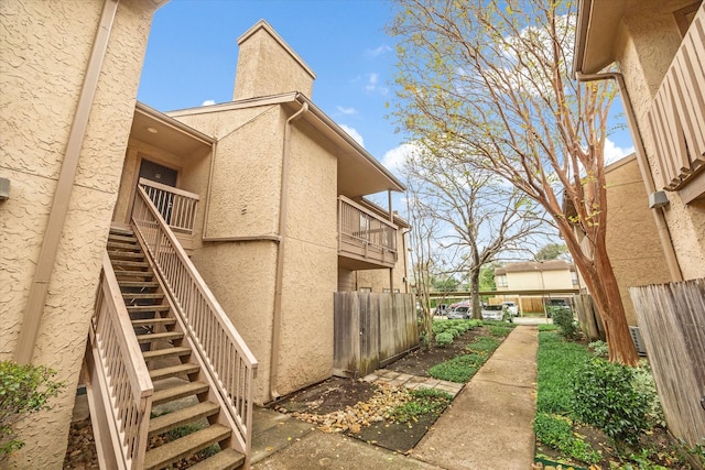 view of side of home with a balcony