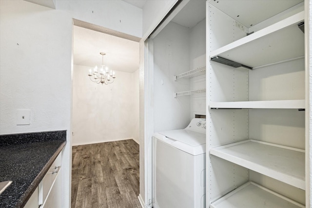 laundry area featuring wood-type flooring, washer / clothes dryer, and a chandelier