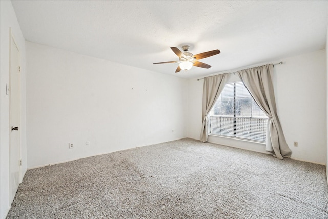 empty room with carpet flooring and ceiling fan