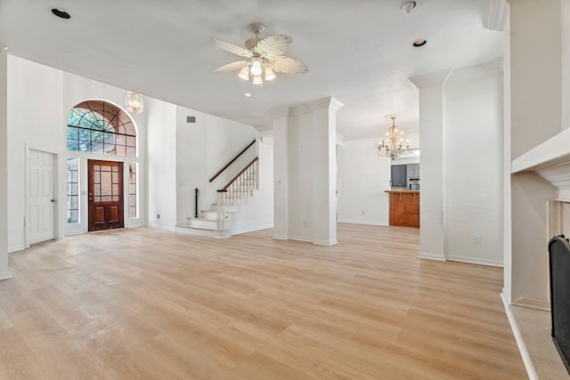 entryway with ceiling fan with notable chandelier and light hardwood / wood-style flooring