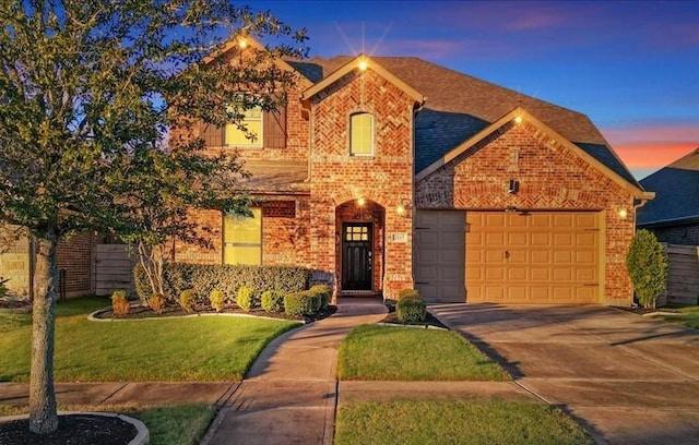 view of front of house featuring a yard and a garage