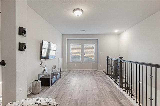 hall with light hardwood / wood-style floors