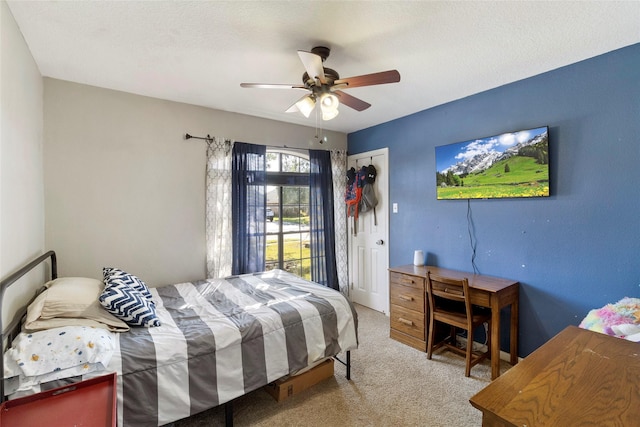 carpeted bedroom featuring ceiling fan, a closet, and a textured ceiling