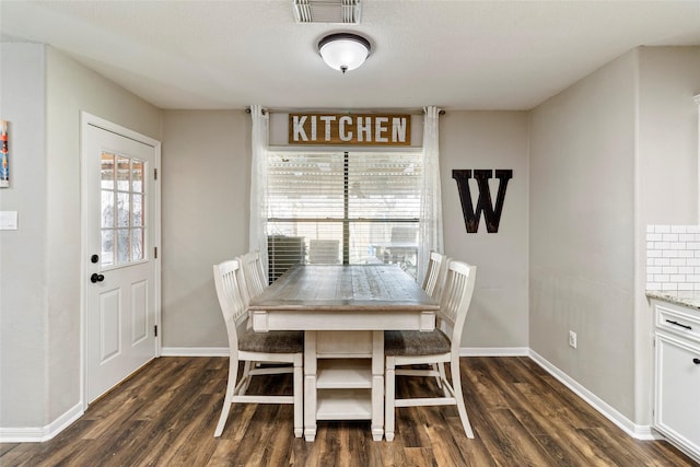 dining space featuring dark hardwood / wood-style flooring