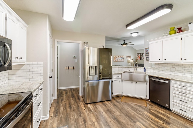 kitchen with white cabinets, appliances with stainless steel finishes, decorative backsplash, sink, and ceiling fan