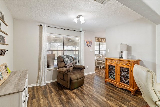 sitting room featuring a textured ceiling and dark hardwood / wood-style flooring