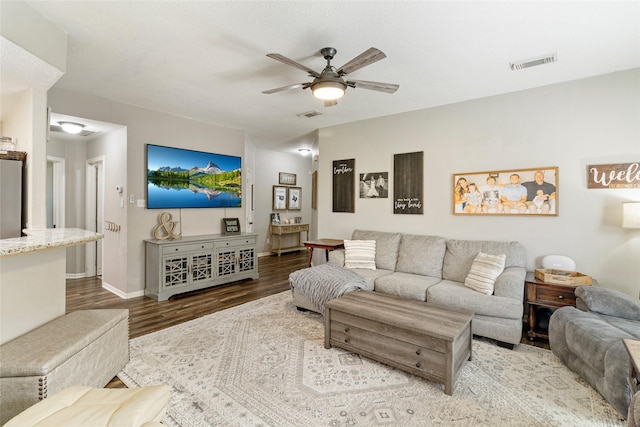 living room with ceiling fan and hardwood / wood-style floors