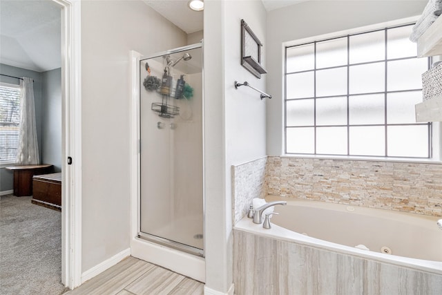 bathroom featuring shower with separate bathtub