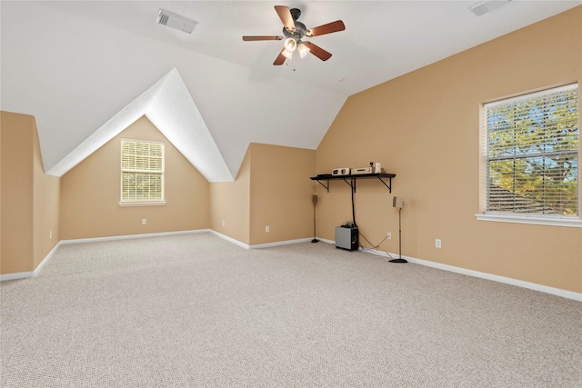 additional living space featuring ceiling fan, light carpet, and vaulted ceiling