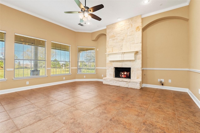 unfurnished living room with tile patterned flooring, a stone fireplace, ceiling fan, and ornamental molding