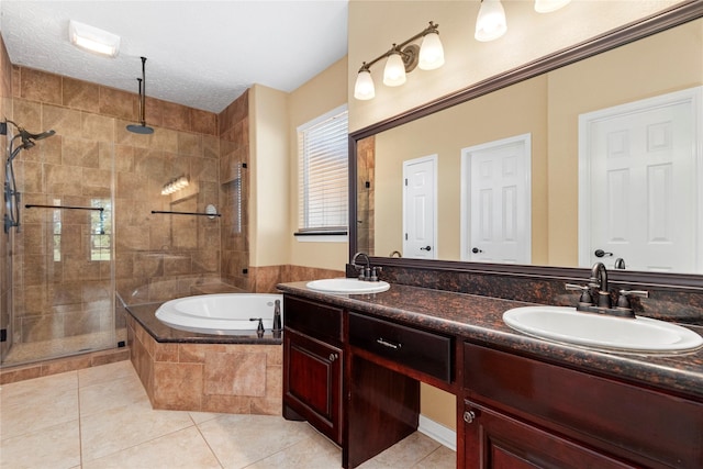 bathroom featuring shower with separate bathtub, vanity, a textured ceiling, and tile patterned floors