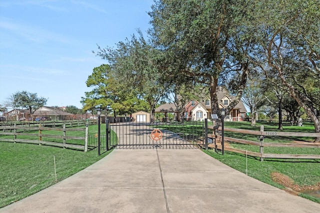 view of gate with a yard