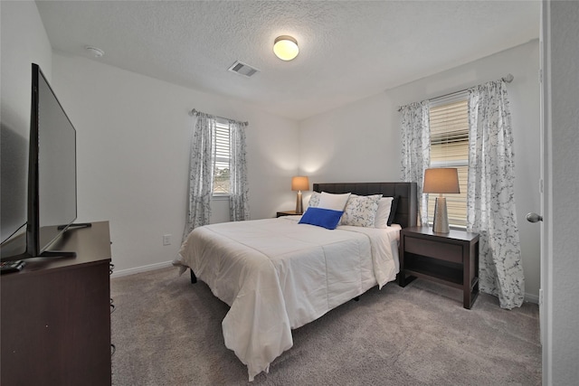 carpeted bedroom with a textured ceiling