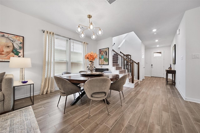 dining area with an inviting chandelier and hardwood / wood-style floors