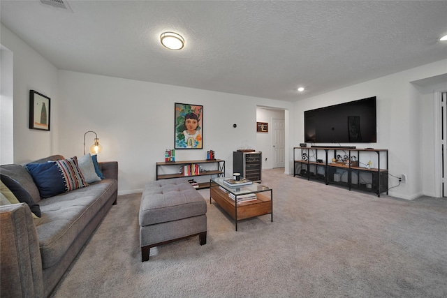 living room featuring carpet floors and a textured ceiling