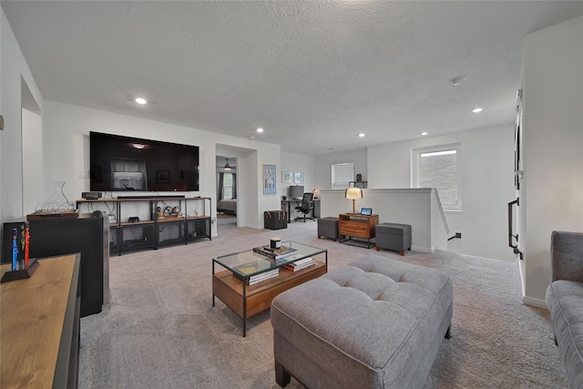 carpeted living room featuring a textured ceiling