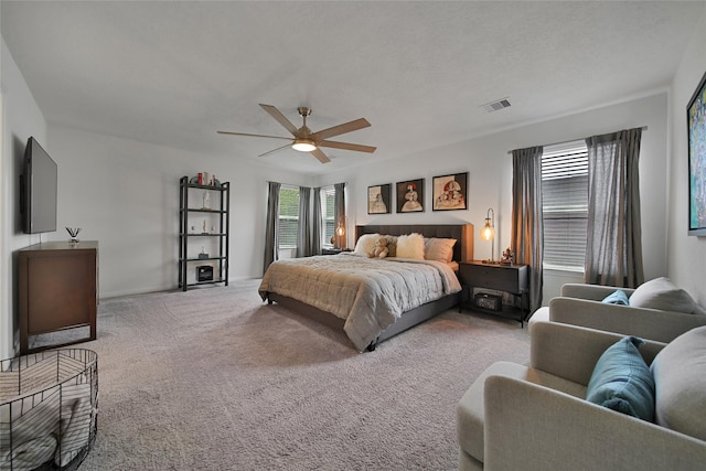 bedroom with ceiling fan and light colored carpet