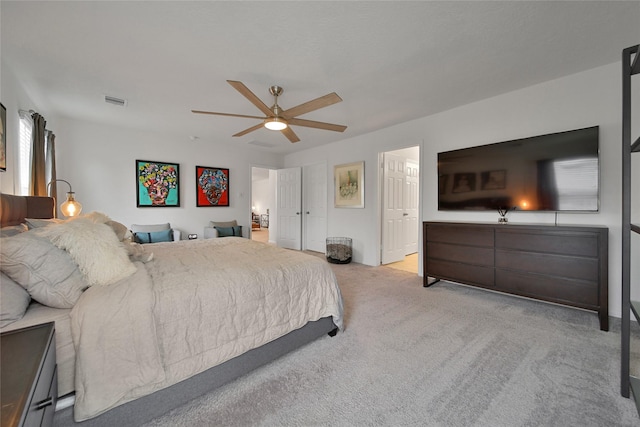 bedroom featuring light colored carpet and ceiling fan