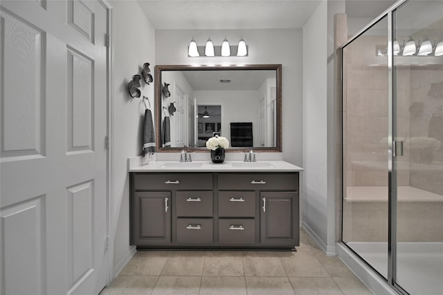 bathroom featuring walk in shower, tile patterned floors, and vanity