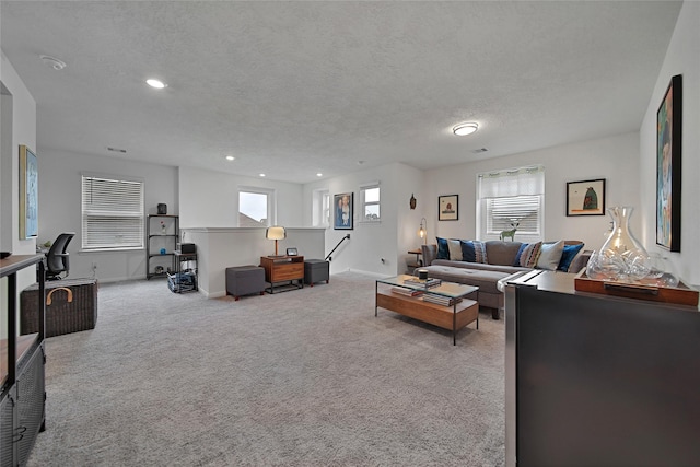 carpeted living room with a textured ceiling