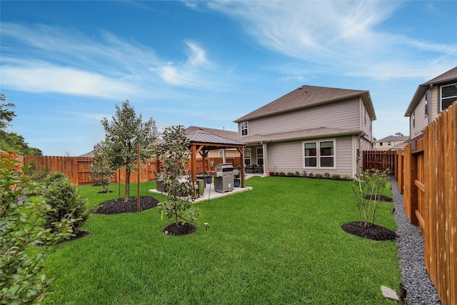 back of property featuring a yard, a gazebo, and a patio