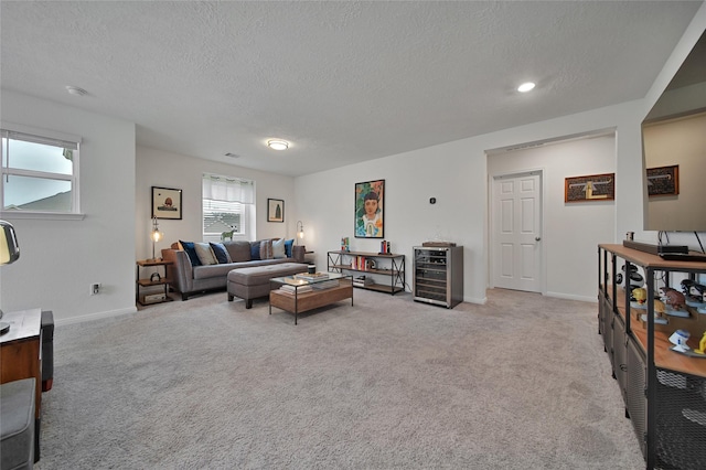 living room with light colored carpet and a textured ceiling