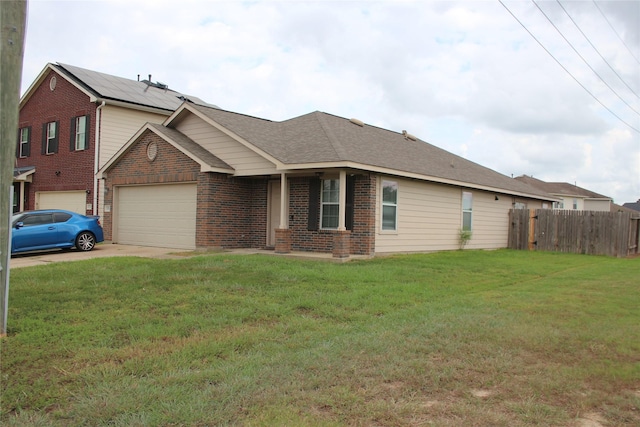 ranch-style home featuring a front lawn and a garage