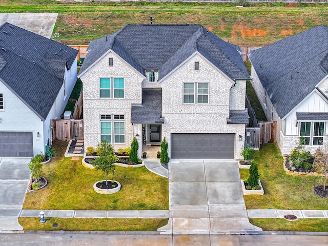 view of front of house with a front yard and a garage