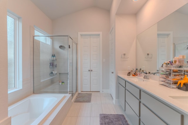 bathroom with separate shower and tub, a healthy amount of sunlight, and lofted ceiling