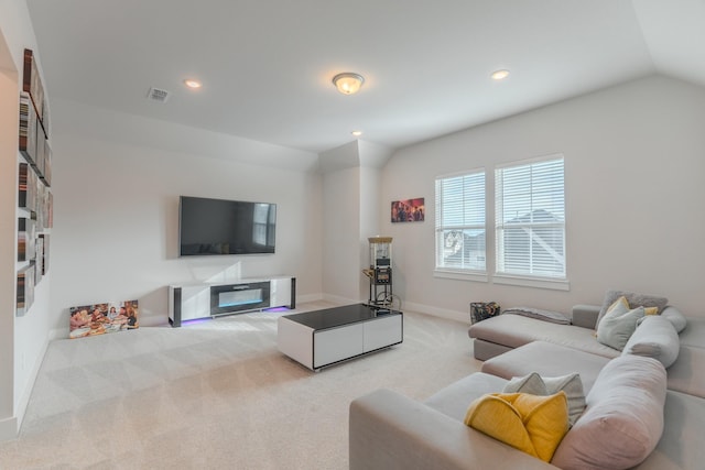 carpeted living room featuring vaulted ceiling