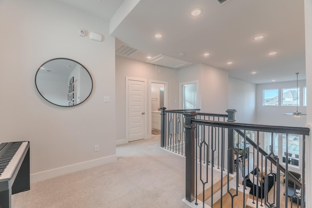 corridor featuring light colored carpet