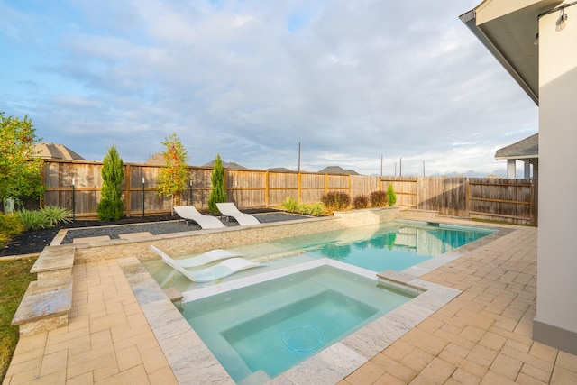 view of swimming pool featuring an in ground hot tub and a patio area