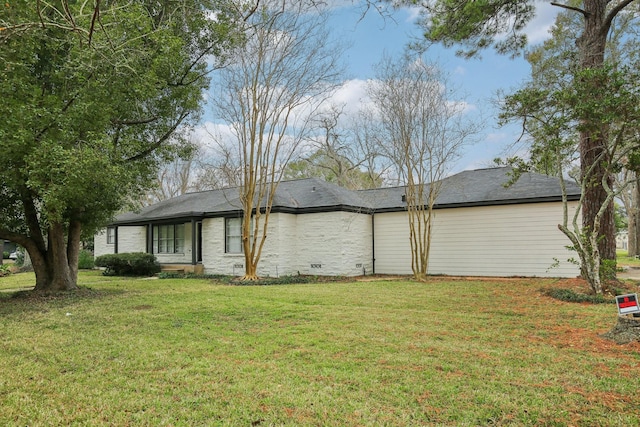 view of side of home with a lawn