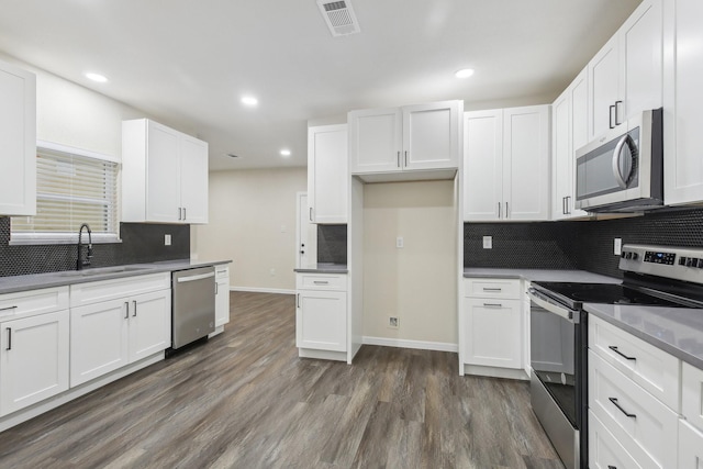 kitchen with white cabinetry, sink, and stainless steel appliances