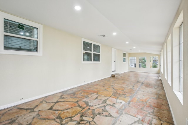 unfurnished room with lofted ceiling