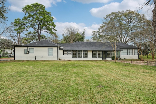 rear view of house with a yard