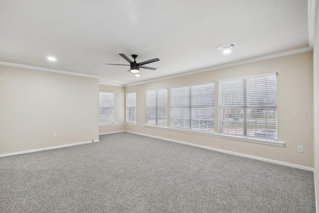 empty room featuring carpet flooring, ceiling fan, and crown molding