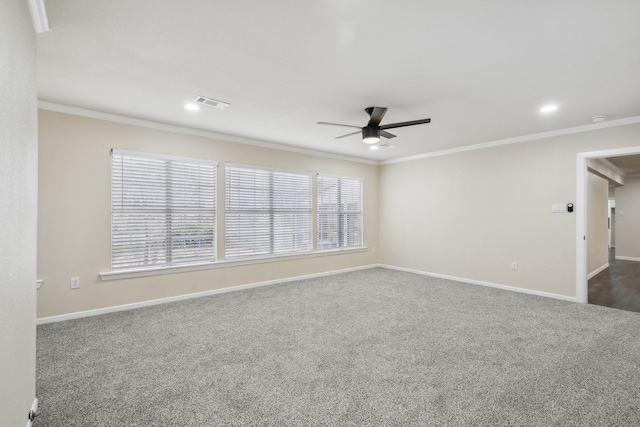 unfurnished room with dark colored carpet, ceiling fan, and ornamental molding