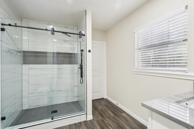 bathroom featuring vanity, wood-type flooring, and walk in shower