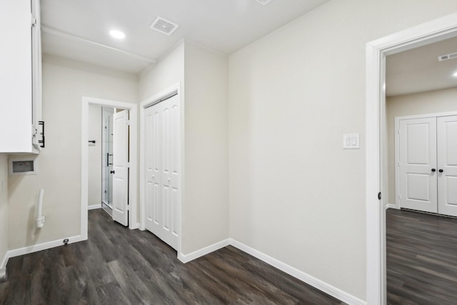 hall with dark wood-type flooring