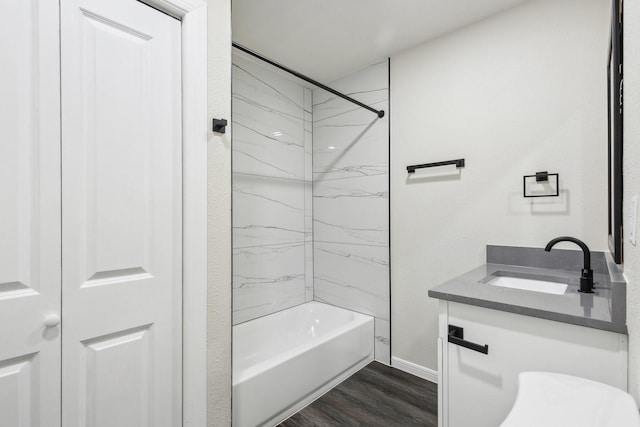 bathroom with hardwood / wood-style floors, vanity, and tiled shower / bath combo