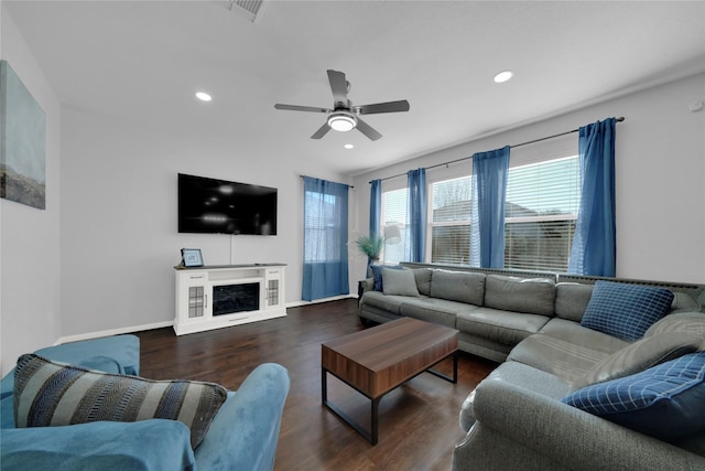 living room featuring ceiling fan and dark wood-type flooring