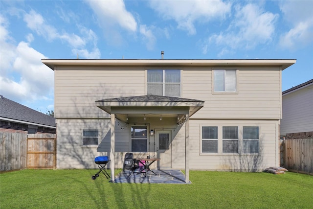 rear view of house featuring a patio and a lawn