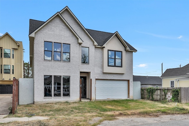 view of front of home with a garage and a front lawn