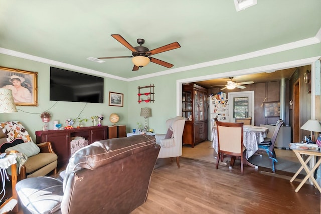 living room with ornamental molding and hardwood / wood-style flooring