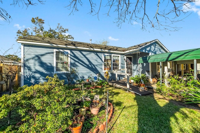 rear view of house featuring a lawn